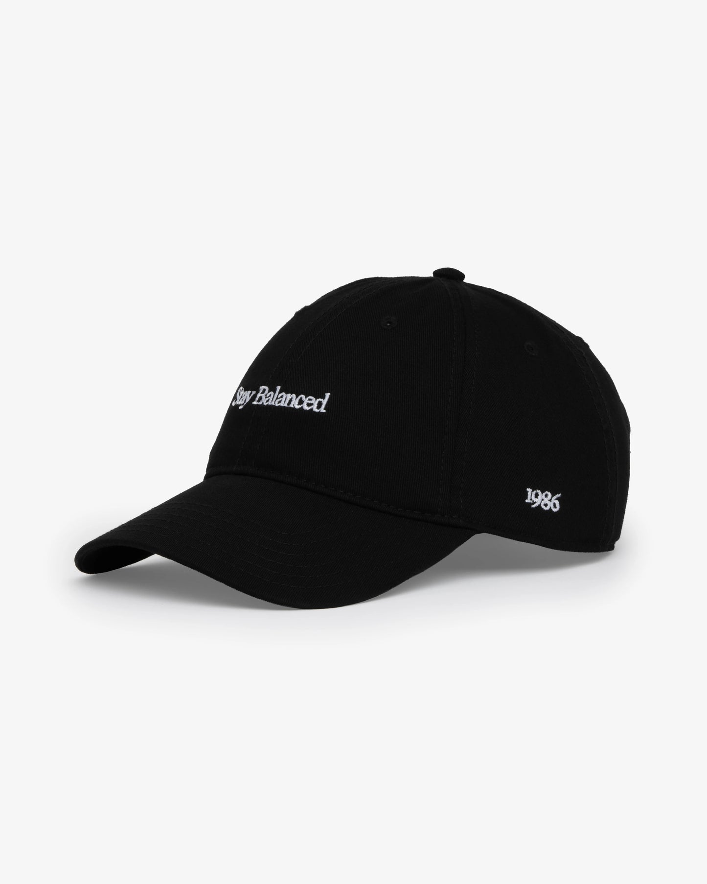 Van Libra Blackwood (black) dad hat with white embroidered text “Stay Balanced” on the front, “1986” stitched on the side, and “VAN LIBRA” on the back above an adjustable strap with brass buckle.