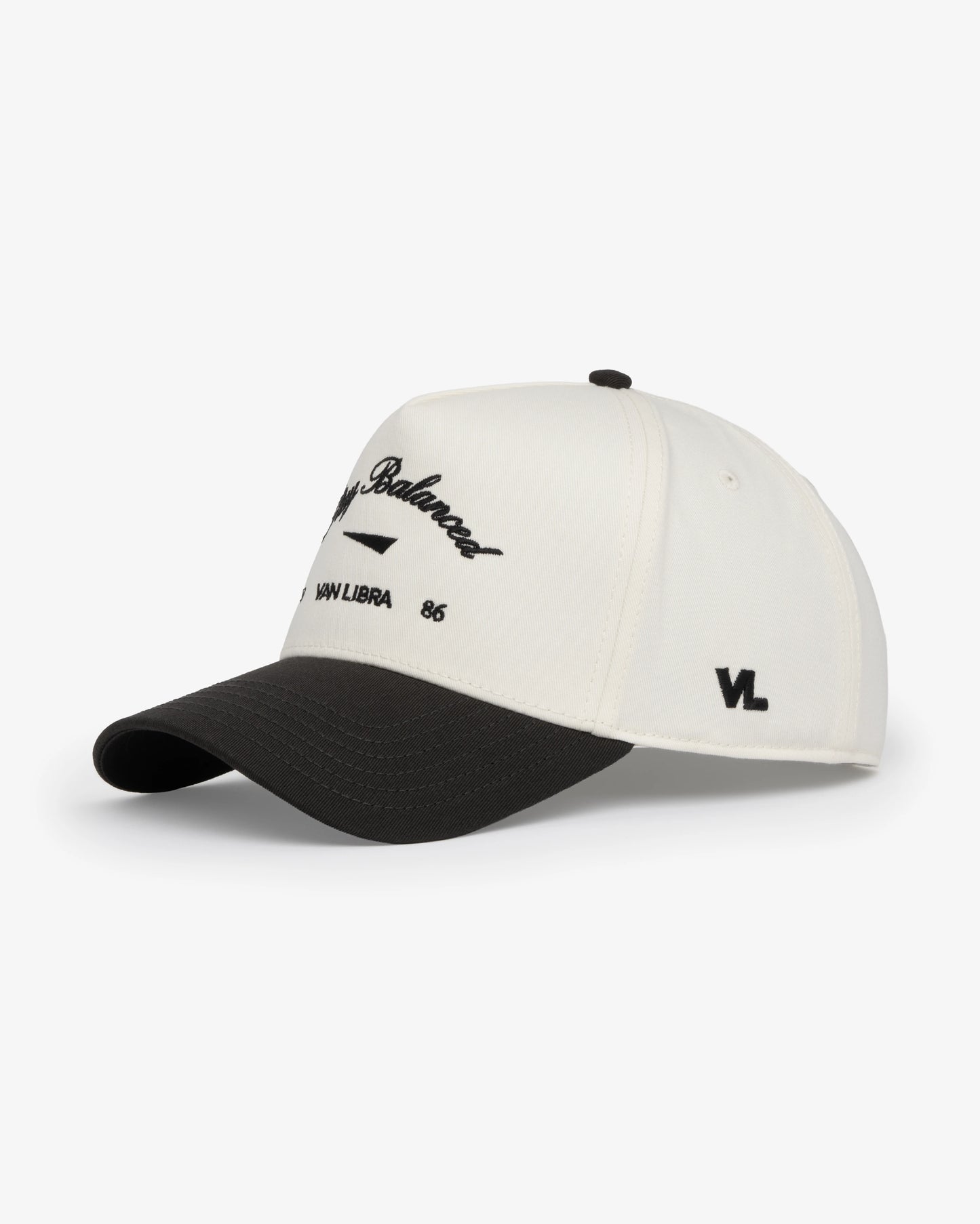 Van Libra Bone/Carbon (cream and dark gray) structured cap with bone colored crown and carbon colored brim. Features black embroidered text “Stay Balanced” with abstract triangle graphic on the front, “1986” and “VAN LIBRA” details, and “VL” stitched on the side, finished with an adjustable carbon colored snapback closure at the back.