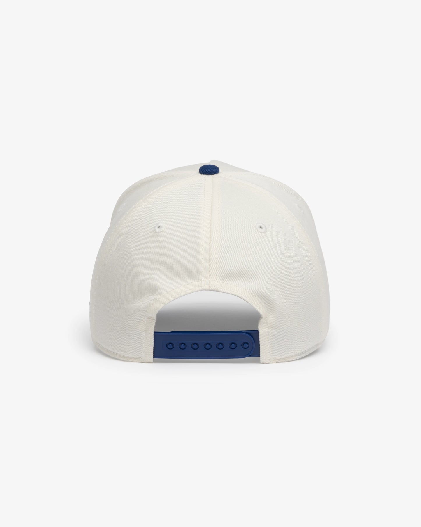 Van Libra Bone/Indigo (cream and blue) structured cap with bone colored crown and indigo colored brim. Features blue embroidered text “Stay Balanced” with abstract triangle graphic on the front, “1986” and “VAN LIBRA” details, and “VL” stitched on the side, finished with an adjustable indigo snapback closure at the back.