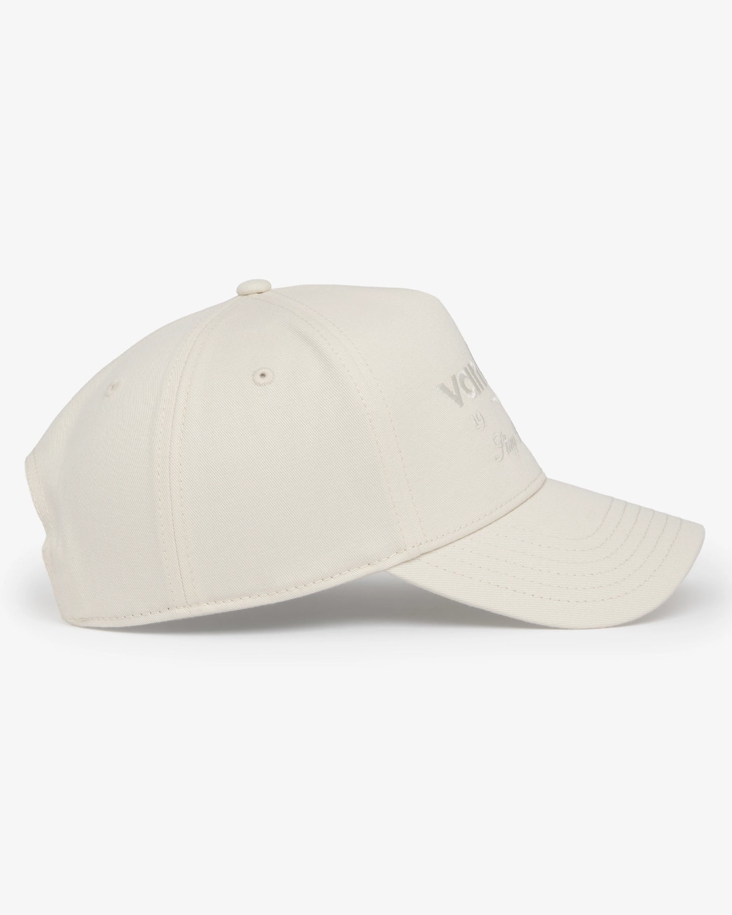 Van Libra Ivory (cream) structured cap with ivory crown and brim. Features cream colored embroidered text “van libra” with abstract triangle graphic on the front, “1986” and “Stay Balanced” lettering on the front, plus “VL” stitched on the side, finished with an adjustable ivory snapback closure at the back.