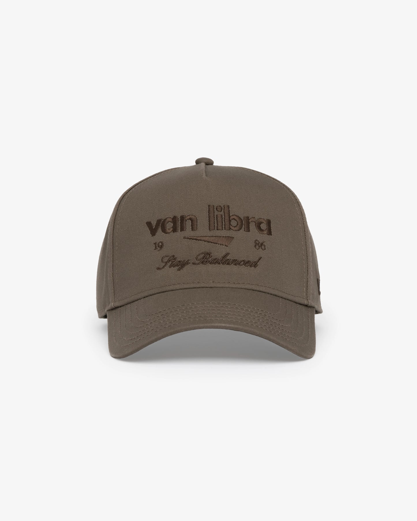 Van Libra Umber (brown) structured cap with umber colored crown and brim. Features brown embroidered text “van libra” with abstract triangle graphic on the front, “1986” and “Stay Balanced” lettering on the front, plus “VL” stitched on the side, finished with an adjustable umber snapback closure at the back.