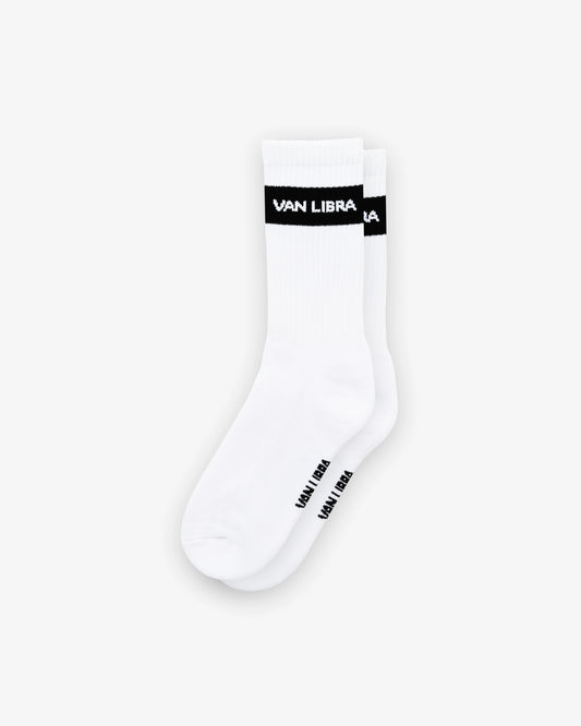 Van Libra Classic Logo crew socks in white with a black jacquard band around the cuff featuring “VAN LIBRA” text. Additional “VAN LIBRA” branding is jacquard knit on the foot.