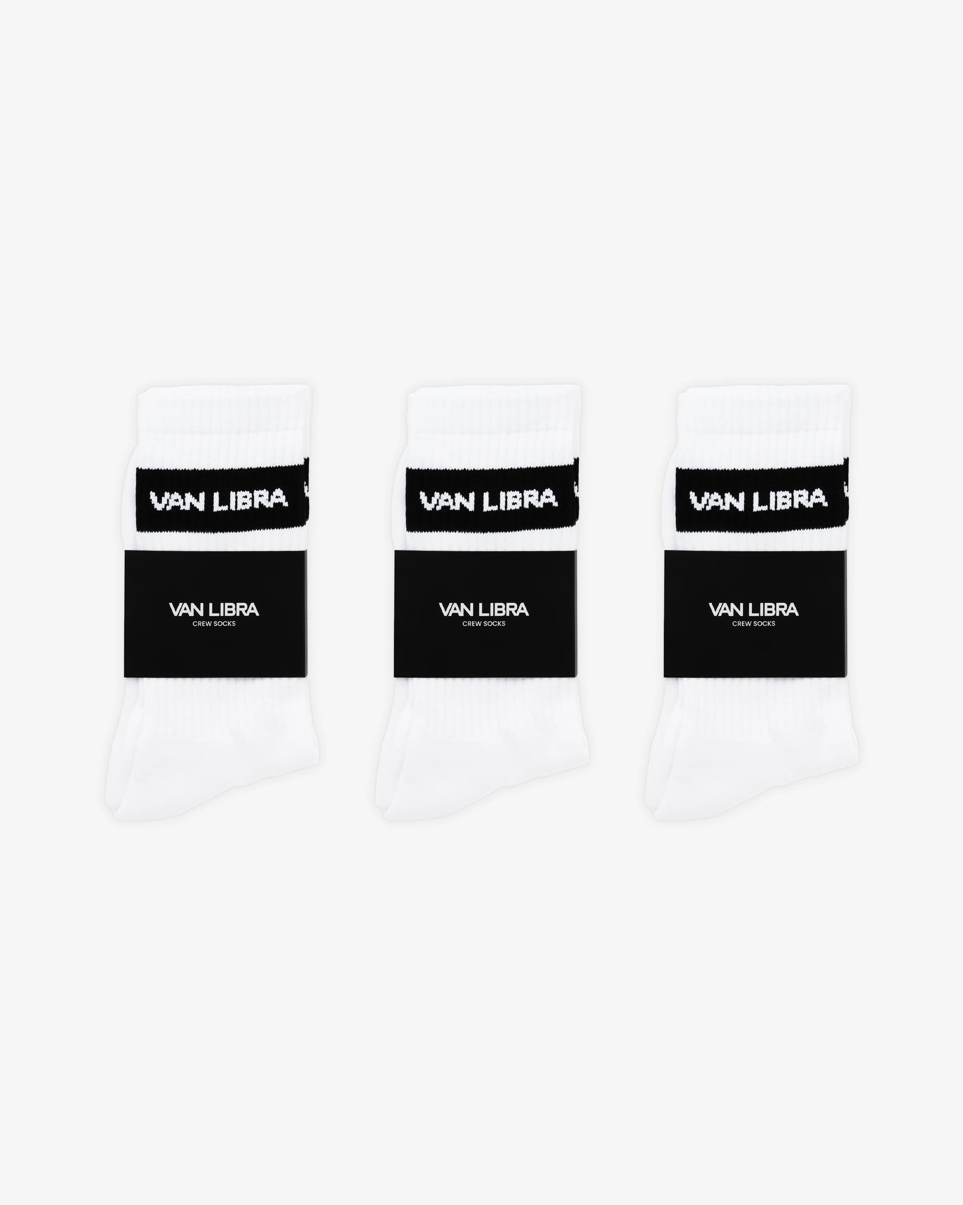Van Libra Classic Logo crew socks in white with a black jacquard band around the cuff featuring “VAN LIBRA” text. Additional “VAN LIBRA” branding is jacquard knit on the foot.