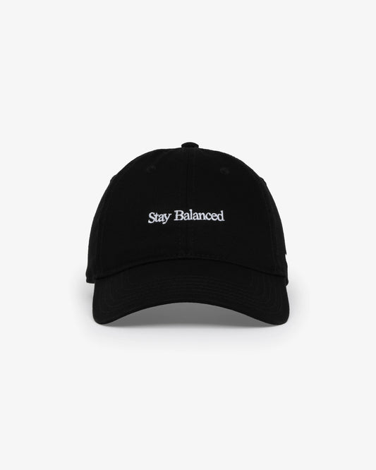 Van Libra Blackwood (black) dad hat with white embroidered text “Stay Balanced” on the front, “1986” stitched on the side, and “VAN LIBRA” on the back above an adjustable strap with brass buckle.