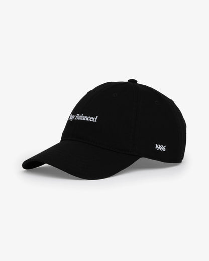 Van Libra Blackwood (black) dad hat with white embroidered text “Stay Balanced” on the front, “1986” stitched on the side, and “VAN LIBRA” on the back above an adjustable strap with brass buckle.
