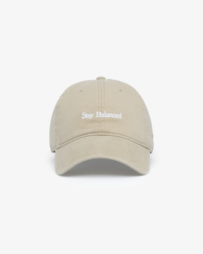 Van Libra Dune (beige) dad hat with white embroidered text “Stay Balanced” on the front, “1986” stitched on the side, and “VAN LIBRA” on the back above an adjustable strap with brass buckle.