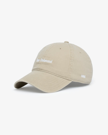Van Libra Dune (beige) dad hat with white embroidered text “Stay Balanced” on the front, “1986” stitched on the side, and “VAN LIBRA” on the back above an adjustable strap with brass buckle.