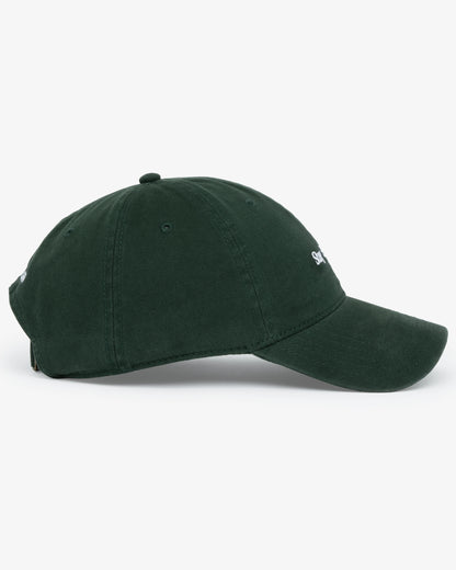 Van Libra Forest (dark green) dad hat with white embroidered text “Stay Balanced” on the front, “1986” stitched on the side, and “VAN LIBRA” on the back above an adjustable strap with brass buckle.