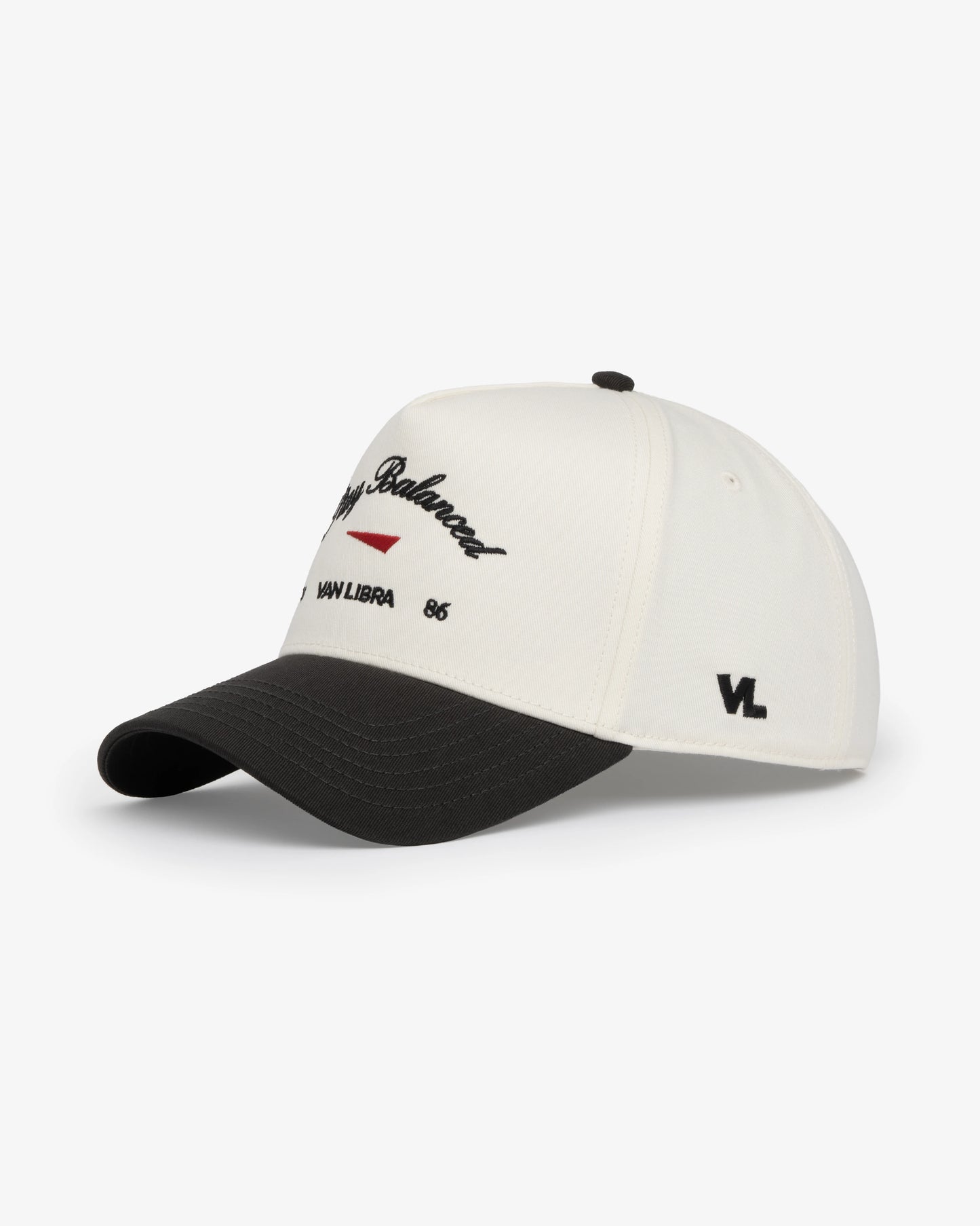 Van Libra Bone/Carbon (cream and dark gray) structured cap with bone colored crown and carbon colored brim. Features black embroidered text “Stay Balanced” with red abstract triangle graphic on the front, black “1986” and “VAN LIBRA” details, and “VL” stitched on the side, finished with an adjustable carbon colored snapback closure at the back.