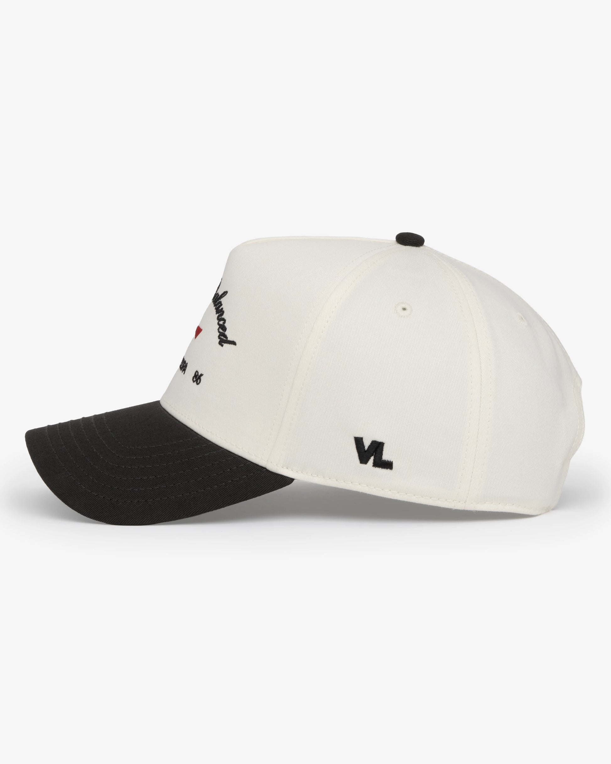 Van Libra Bone/Carbon (cream and dark gray) structured cap with bone colored crown and carbon colored brim. Features black embroidered text “Stay Balanced” with red abstract triangle graphic on the front, black “1986” and “VAN LIBRA” details, and “VL” stitched on the side, finished with an adjustable carbon colored snapback closure at the back.