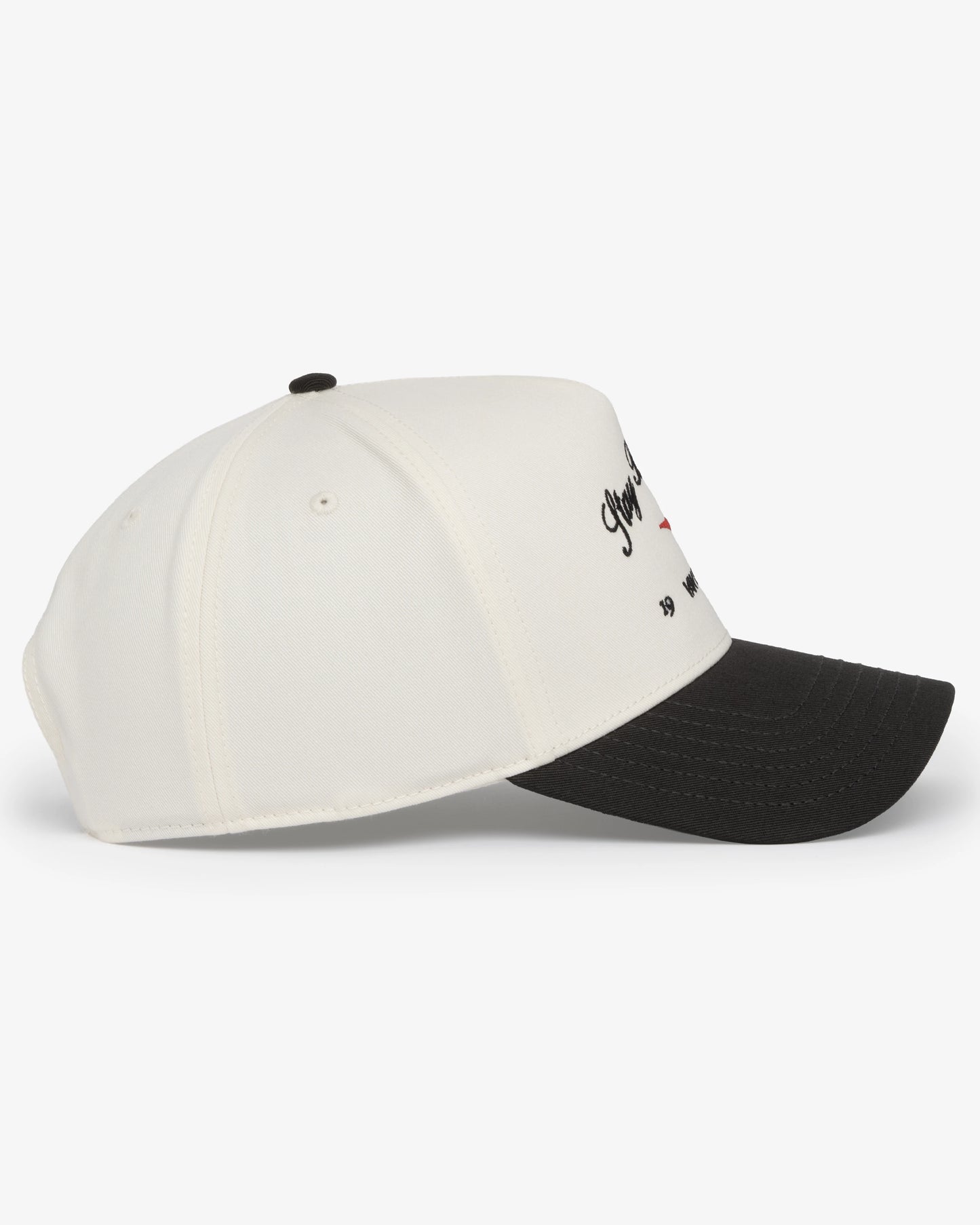 Van Libra Bone/Carbon (cream and dark gray) structured cap with bone colored crown and carbon colored brim. Features black embroidered text “Stay Balanced” with red abstract triangle graphic on the front, black “1986” and “VAN LIBRA” details, and “VL” stitched on the side, finished with an adjustable carbon colored snapback closure at the back.