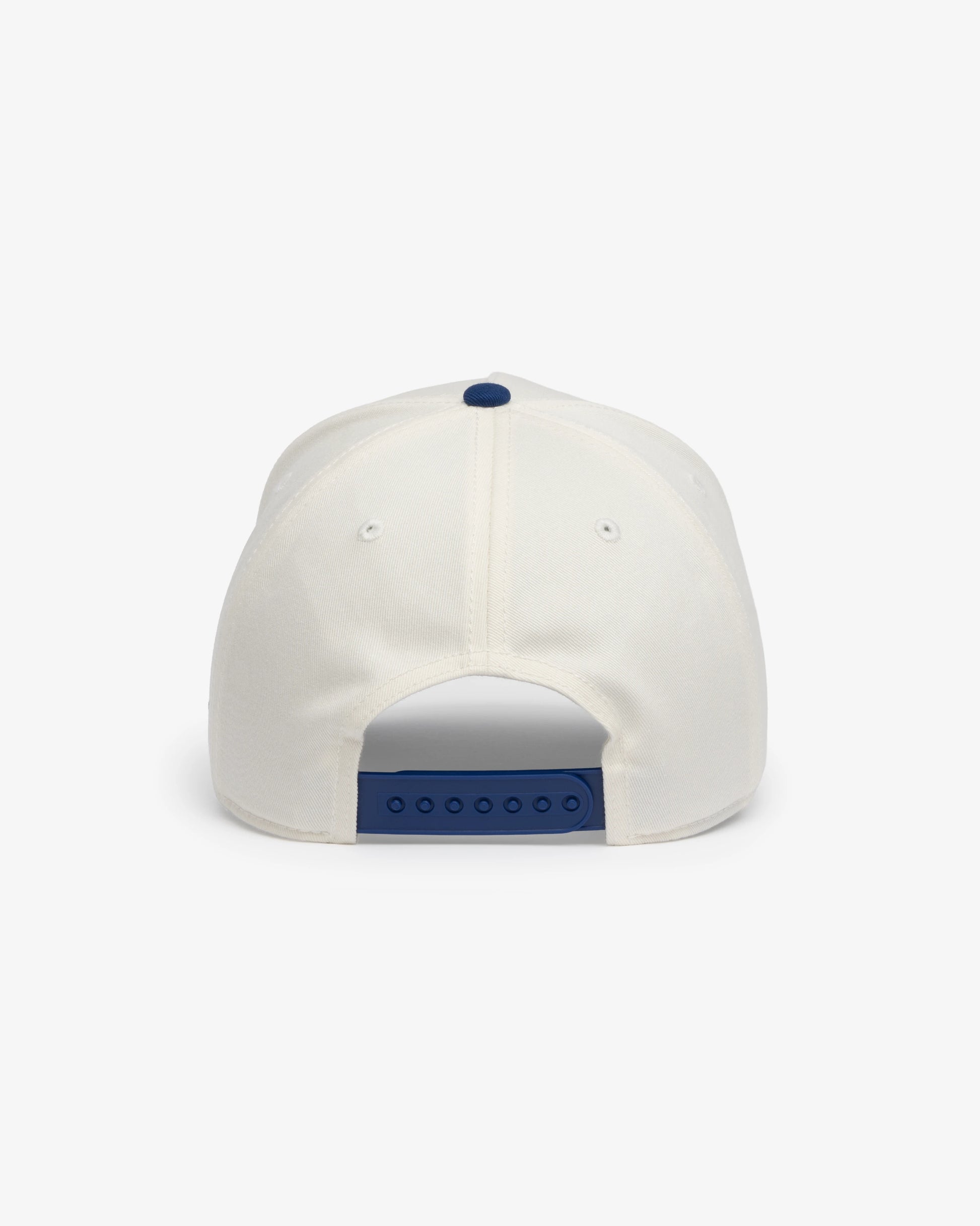 Van Libra Bone/Indigo (cream and blue) structured cap with bone colored crown and indigo colored brim. Features blue embroidered text “Stay Balanced” with abstract triangle graphic on the front, “1986” and “VAN LIBRA” details, and “VL” stitched on the side, finished with an adjustable indigo snapback closure at the back.