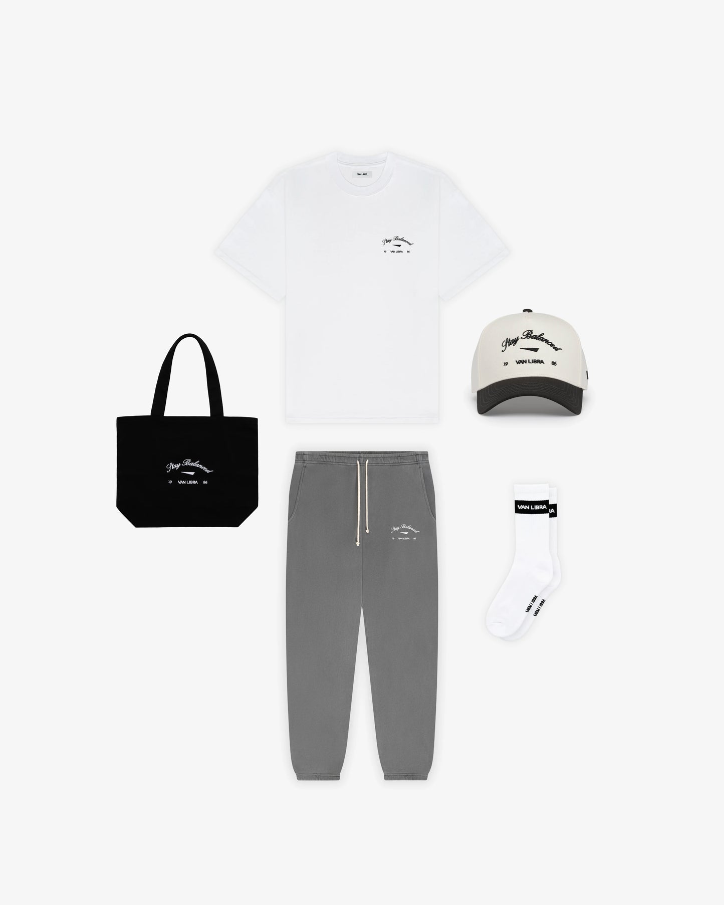 Van Libra Blackwood (black) canvas tote bag with white embroidery. Features “Stay Balanced” text above an abstract triangle graphic, with “VAN LIBRA” and the numbers “19” and “86” stitched below.