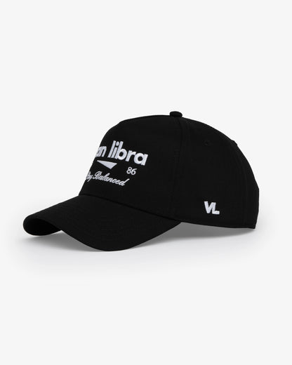 Van Libra Blackwood (black) structured cap with blackwood colored crown and brim. Features white embroidered text “van libra” with abstract triangle graphic on the front, “1986” and “Stay Balanced” lettering on the front, plus “VL” stitched on the side, finished with an adjustable blackwood snapback closure at the back.
