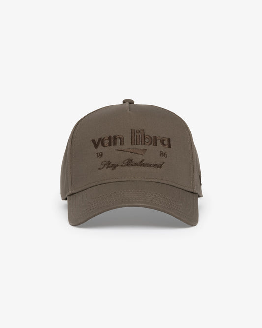 Van Libra Umber (brown) structured cap with umber colored crown and brim. Features brown embroidered text “van libra” with abstract triangle graphic on the front, “1986” and “Stay Balanced” lettering on the front, plus “VL” stitched on the side, finished with an adjustable umber snapback closure at the back.