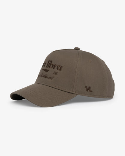Van Libra Umber (brown) structured cap with umber colored crown and brim. Features brown embroidered text “van libra” with abstract triangle graphic on the front, “1986” and “Stay Balanced” lettering on the front, plus “VL” stitched on the side, finished with an adjustable umber snapback closure at the back.